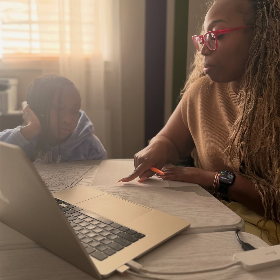 Katrina Carlos tutoring a student on a laptop
